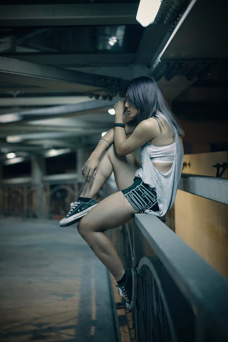 human woman sitting on railing person