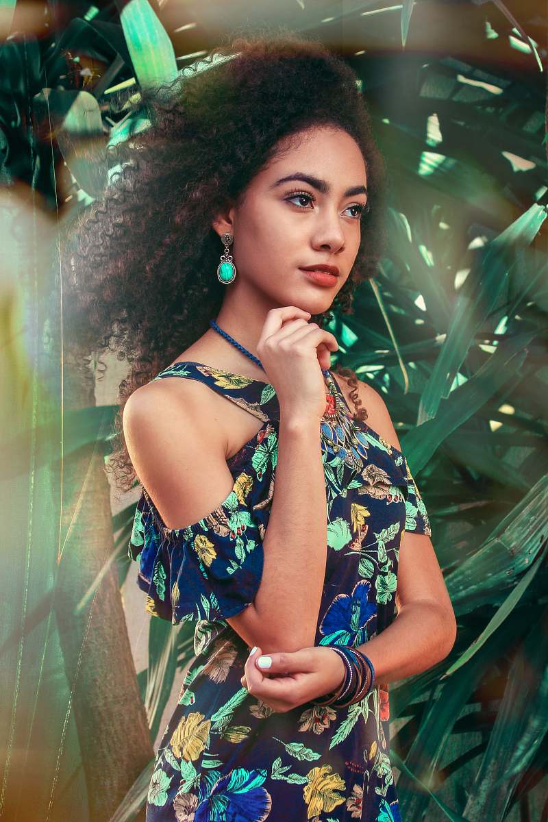 human woman standing against green-leaf plant person