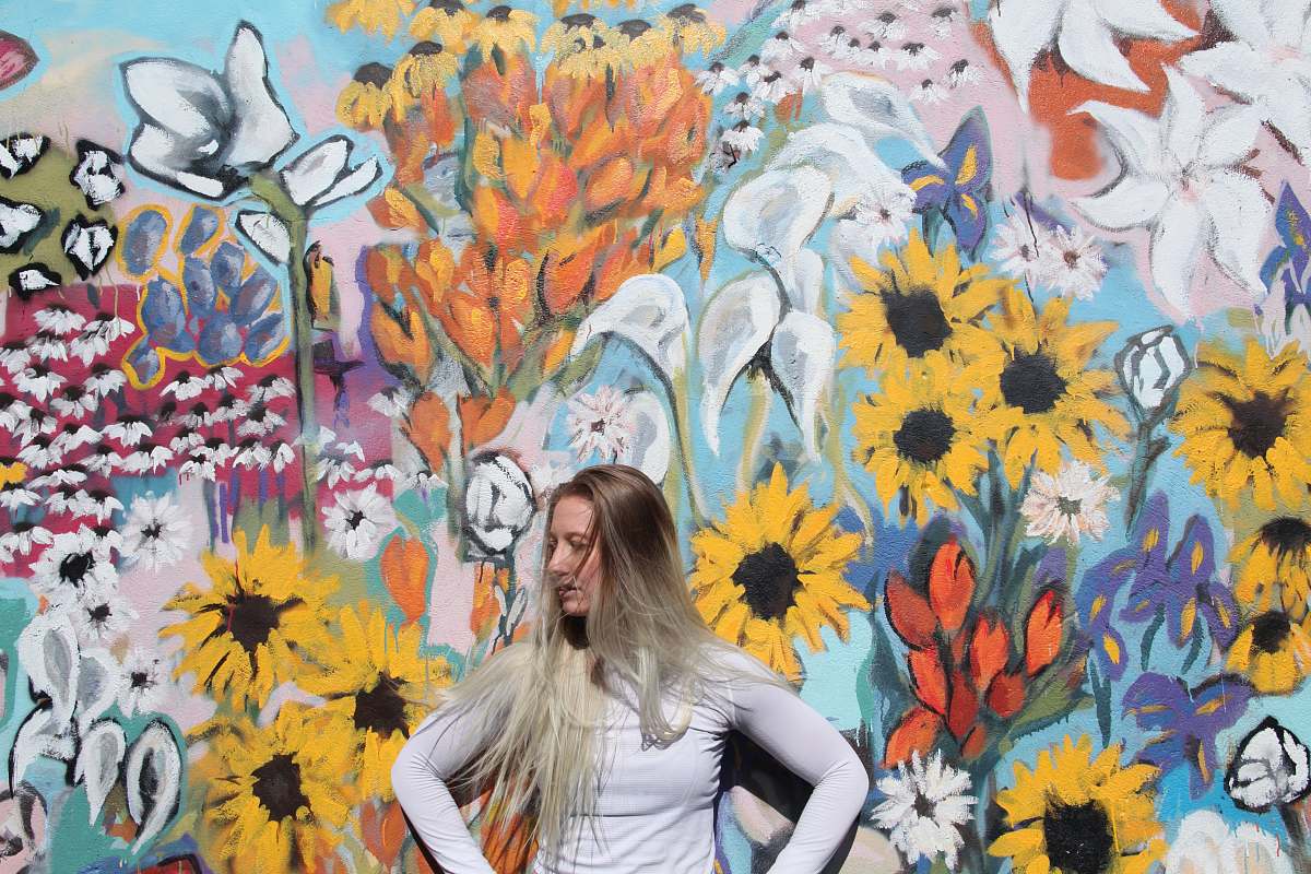 human woman standing in front of graffiti person
