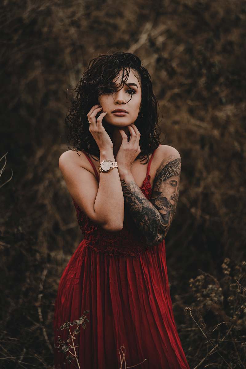person woman standing in the middle of grasses tattoo