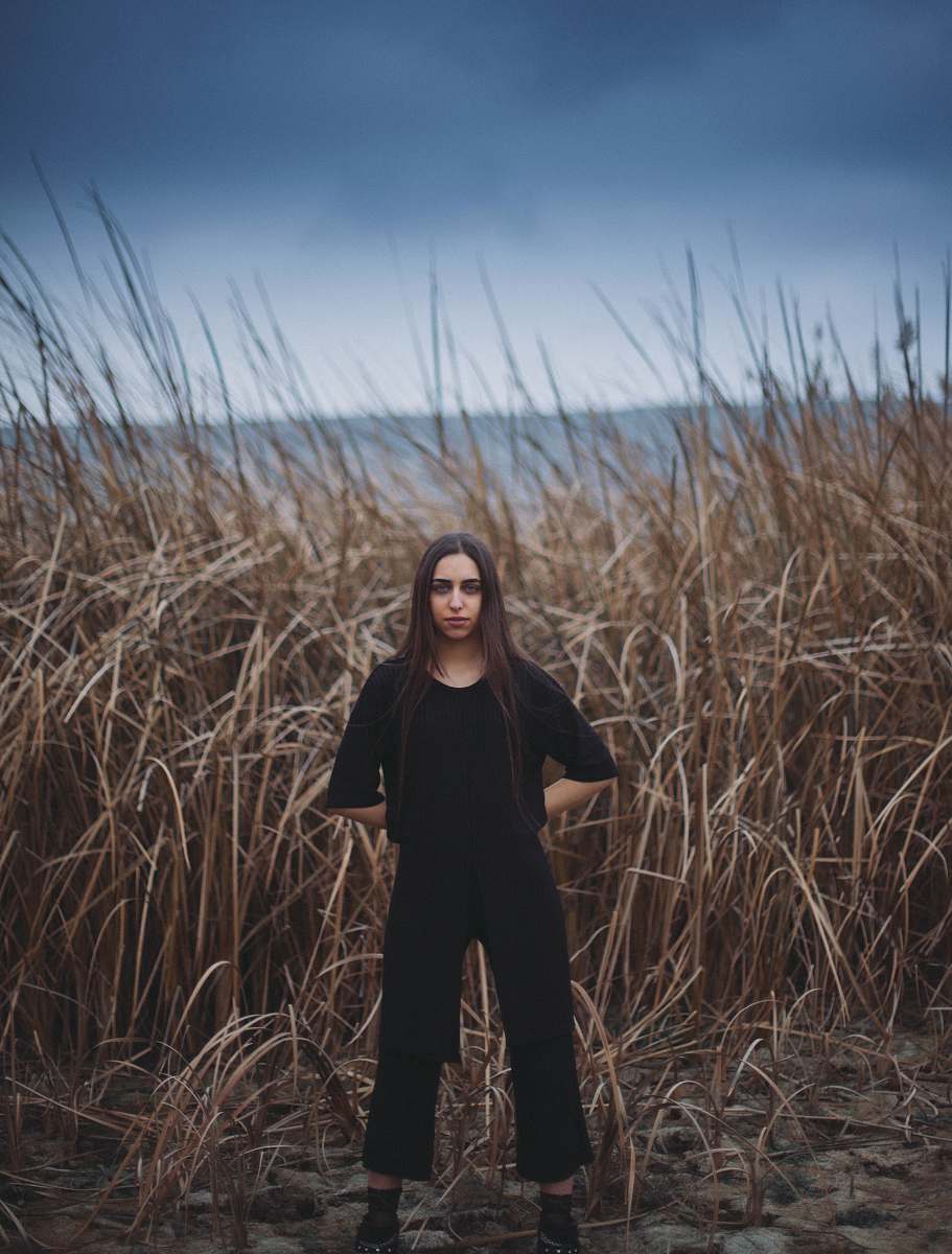 person woman standing near brown grass field human
