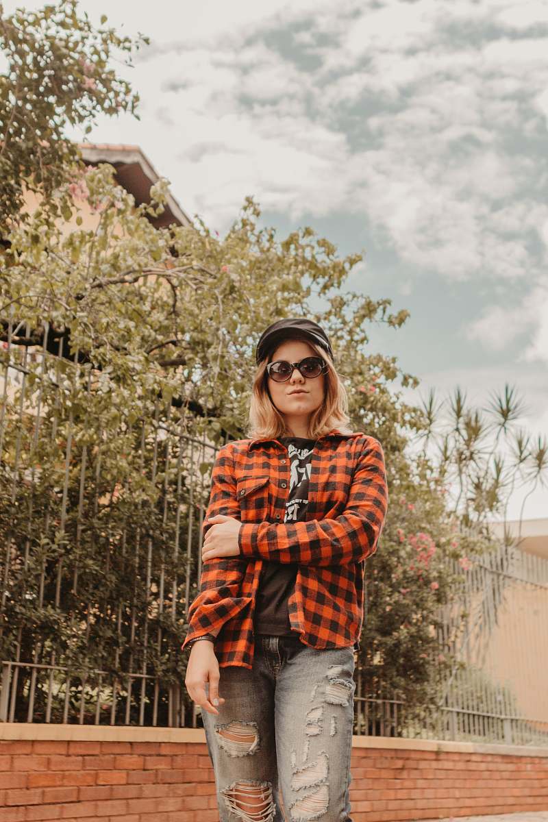 human woman standing near fence while posing person