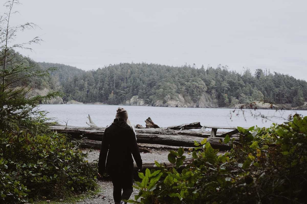 person woman standing near the green plant and log during daytime human