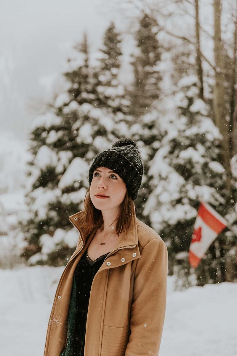 female woman standing on snow covered place beanie