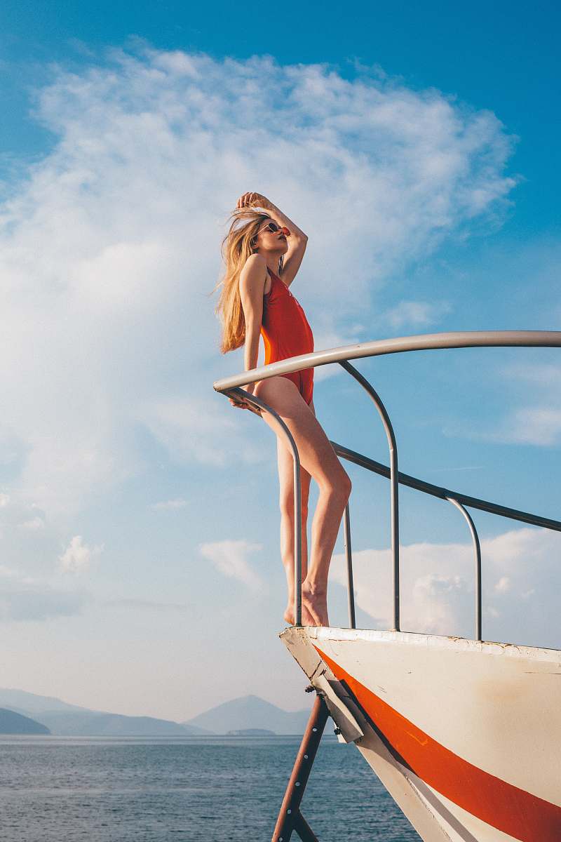 person woman standing on white yacht boat