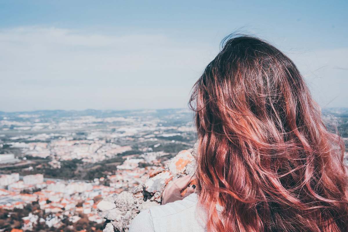 person woman staring the city buildings human