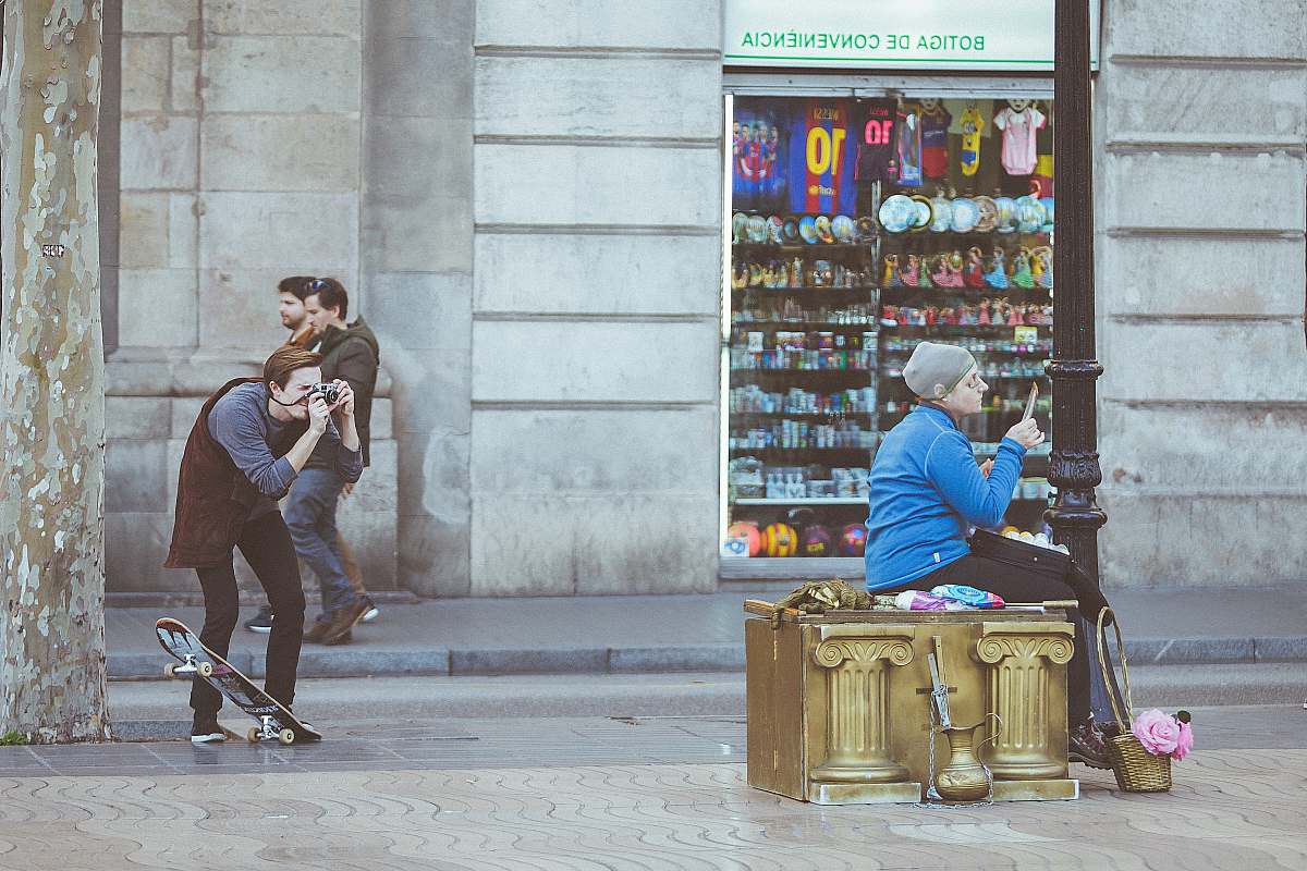 human woman taking picture sitting on brown wooden table skateboard
