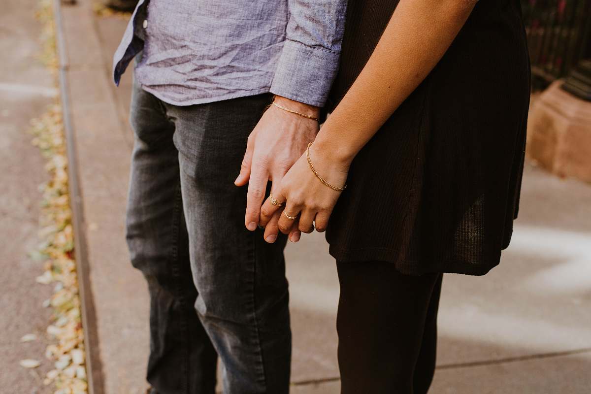 couple woman touching man's hand holding hands