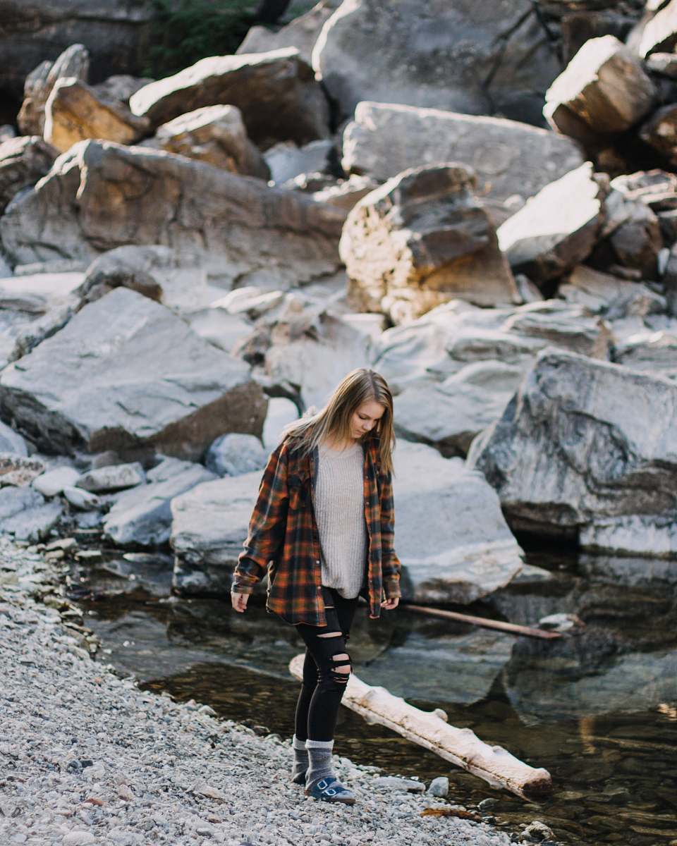 human woman walking beside body of water person
