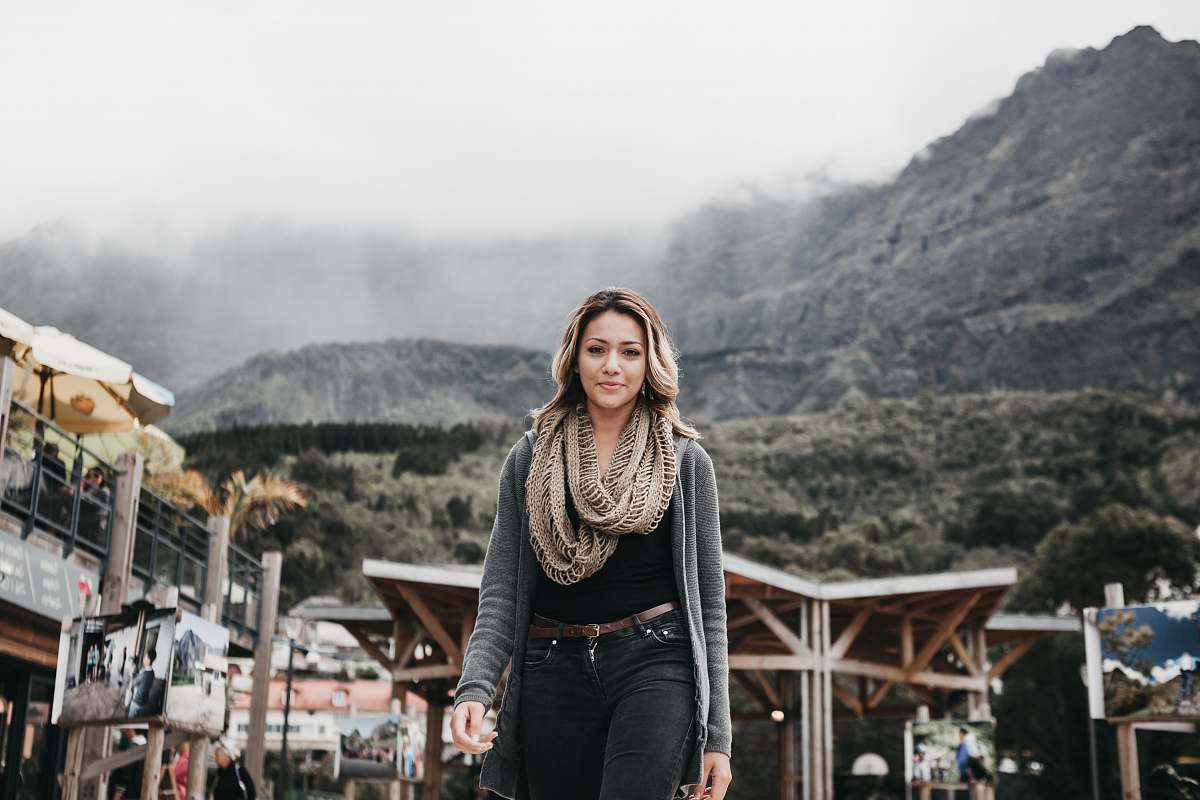 person woman wearing black denim bottoms standing near building human