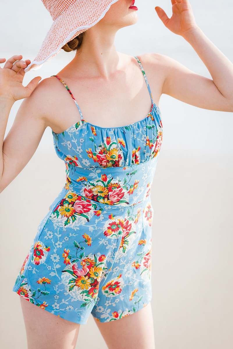 person woman wearing blue floral rompers and brown hat human