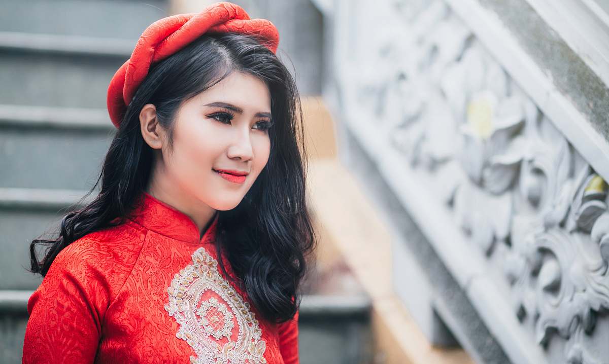 human woman wearing red cheongsam top near stair person