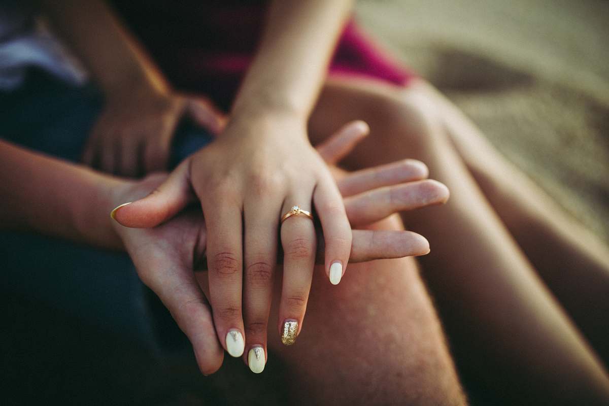 human woman's hand placed on top of man's palm person