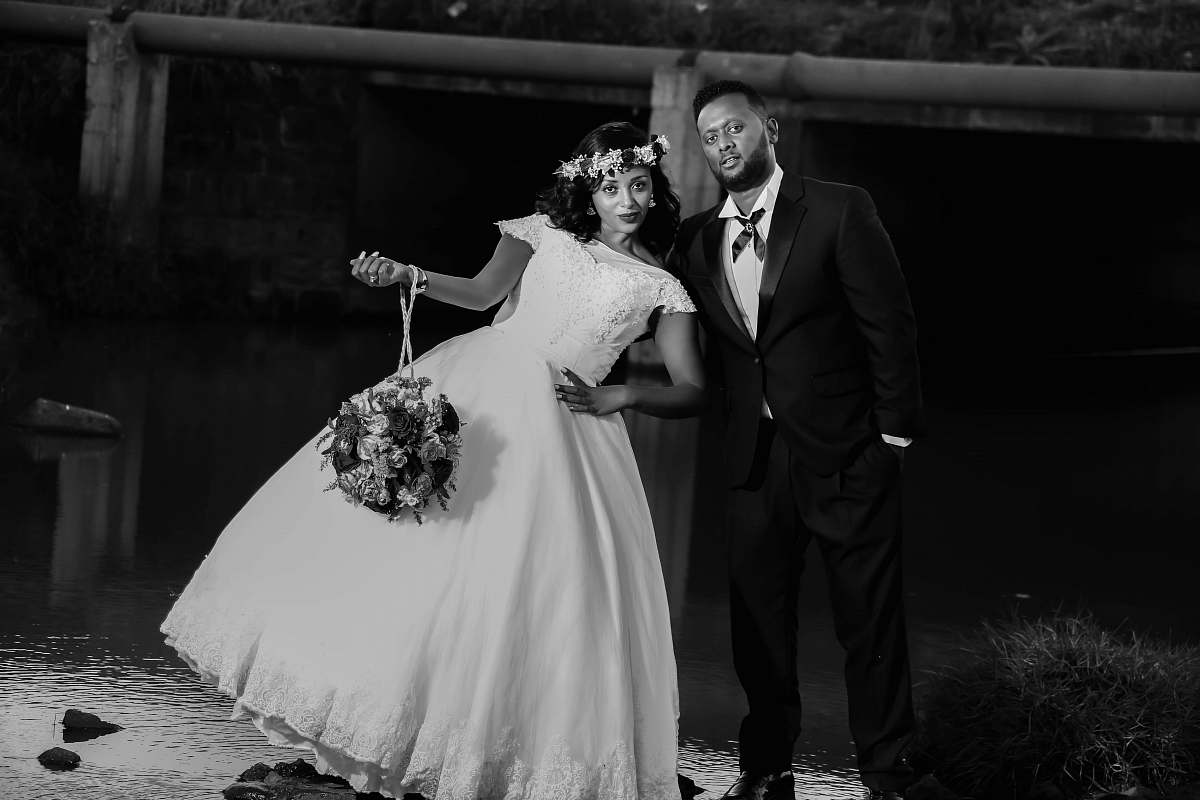 human bride and groom taking group picture black-and-white