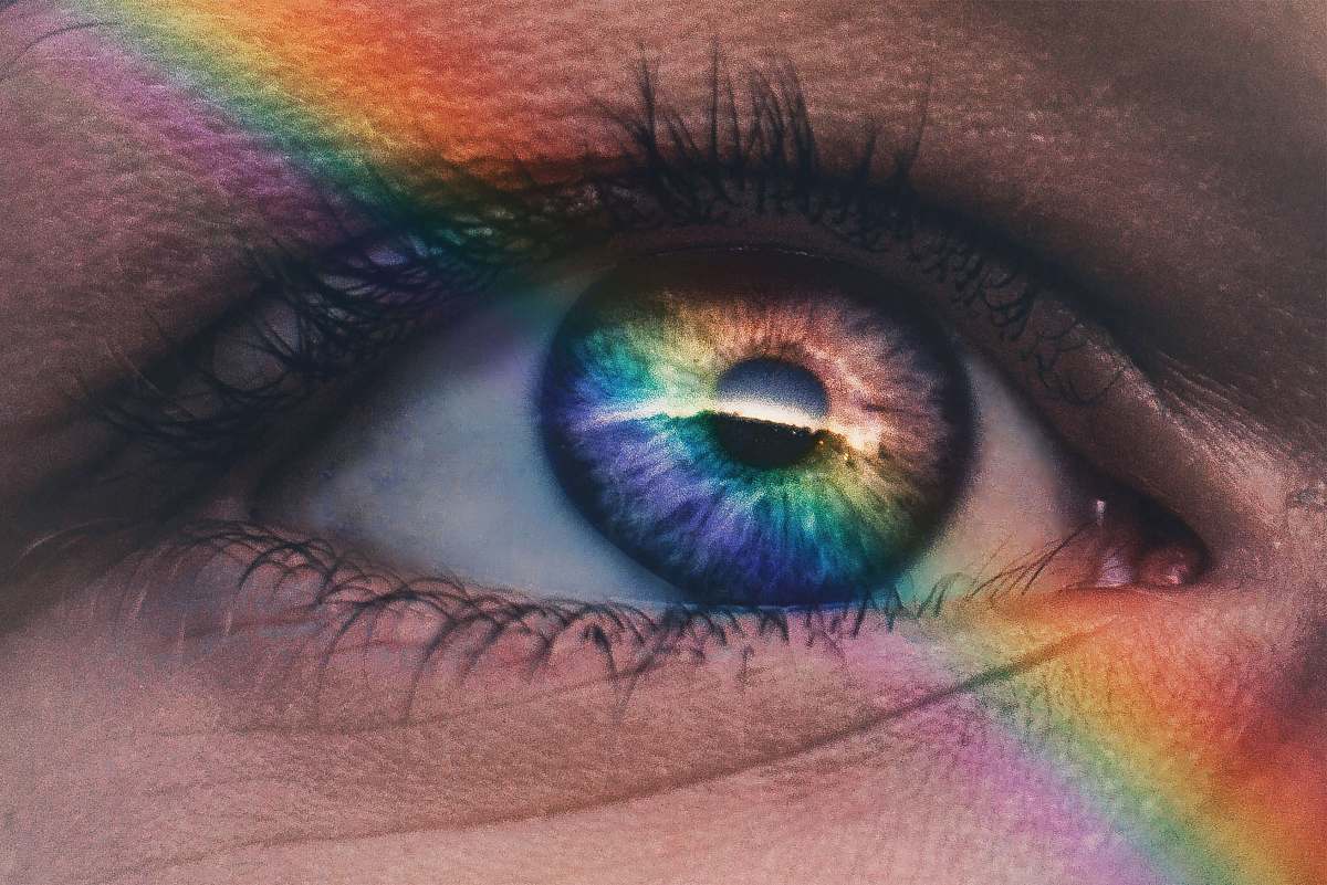 people close up photography of rainbow rays on eye human