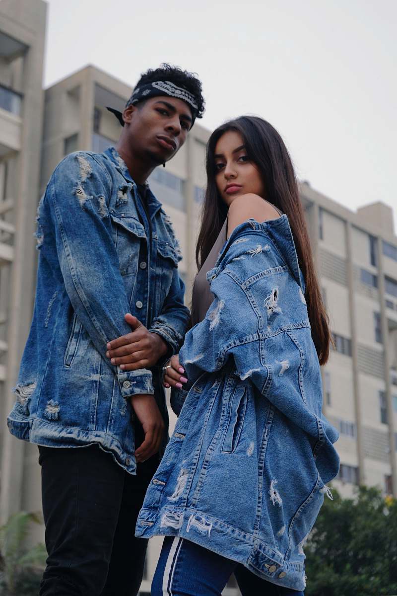 jeans couple wearing distress denim jackets denim