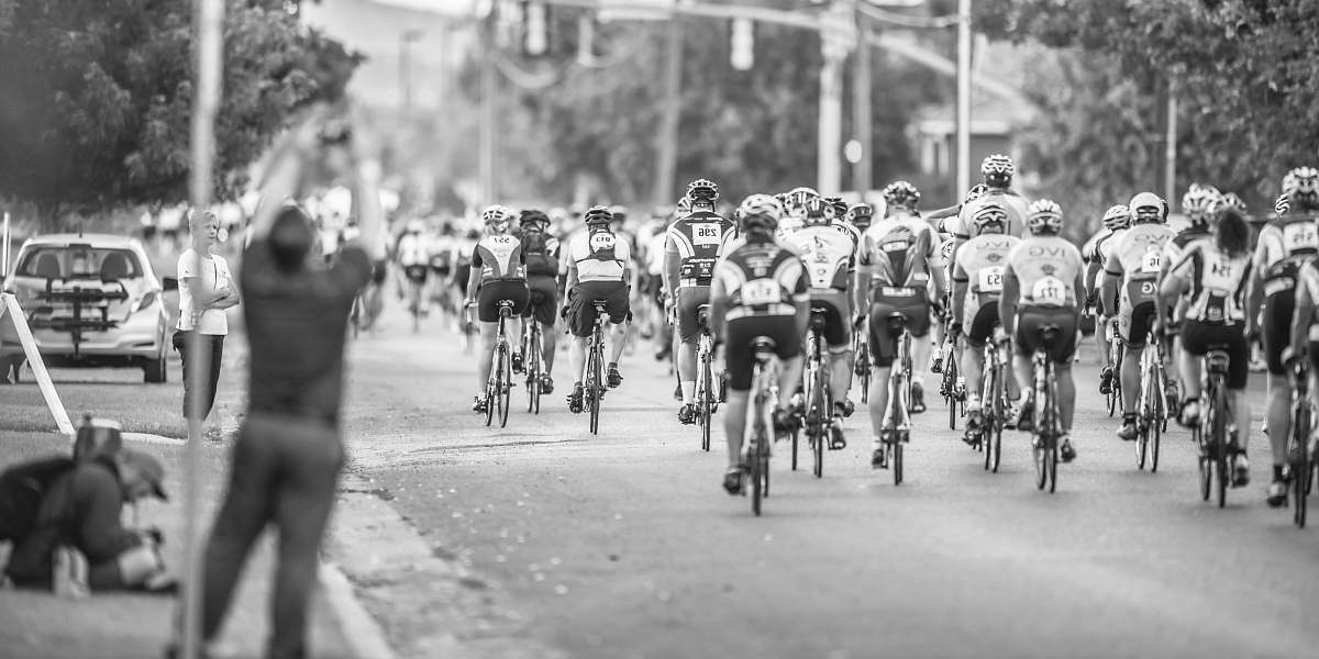 black-and-white grayscale photo of cycler on the road bicycle
