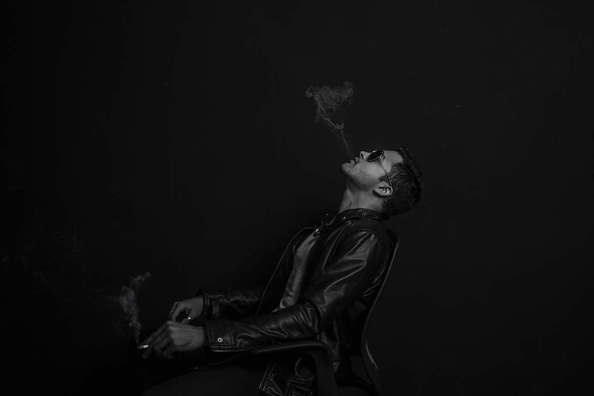 black-and-white grayscale photo of man with cigarette stick man