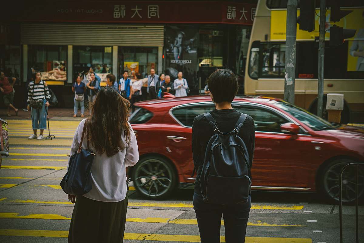 people man and woman standing near red car human