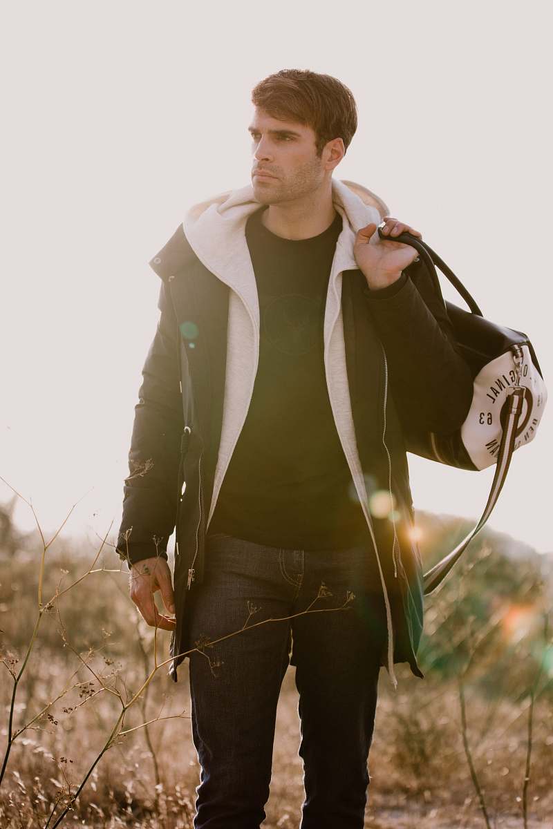 people man holding a duffel bag human