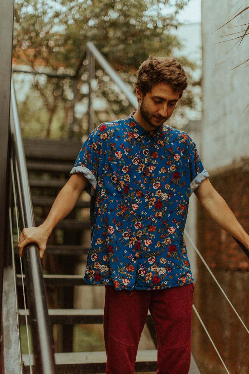 human man holding bar while walking down stair people