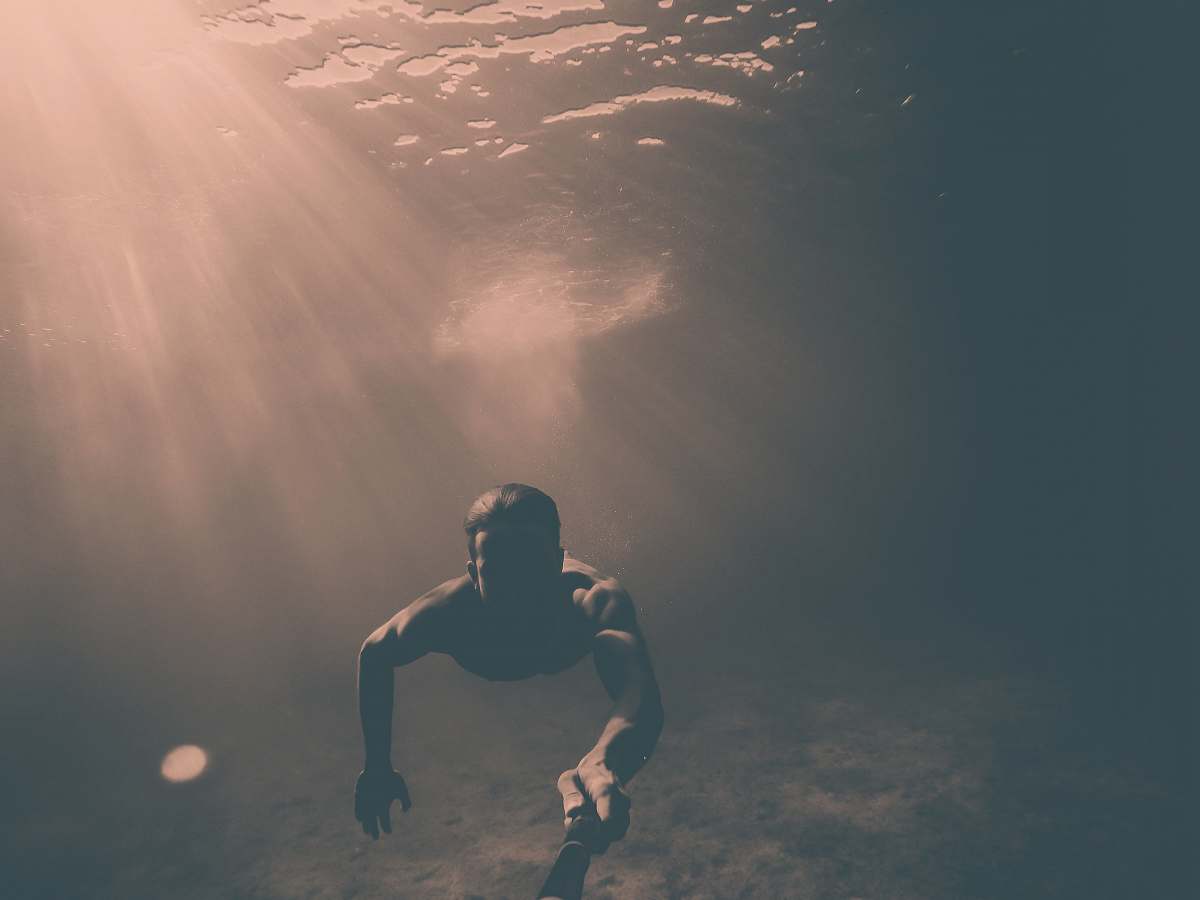 people man holding black monopod while under the sea croatia