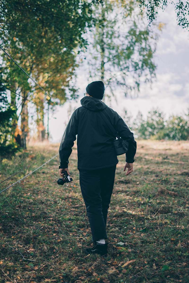 human man holding camera during daytime people