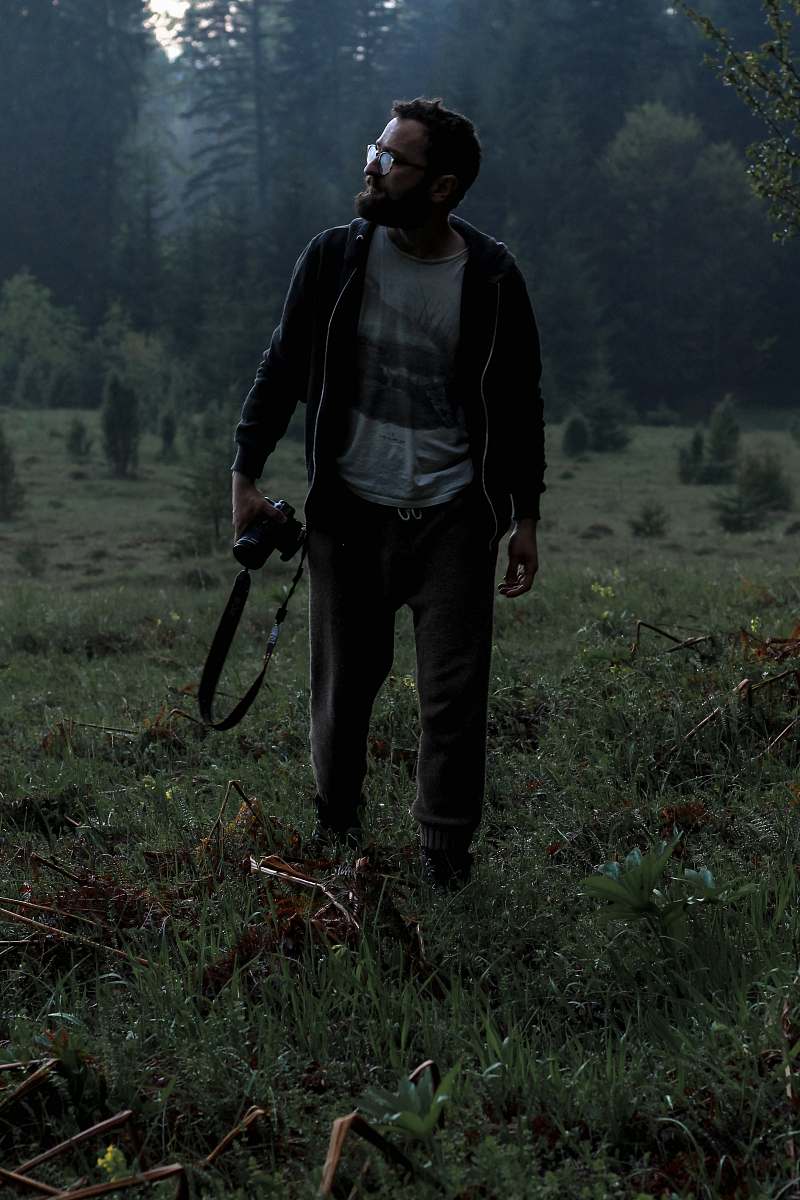 human man holding camera on grass field people