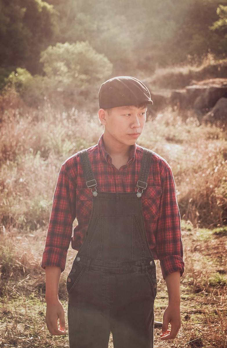 human man in black overalls walking on grass people