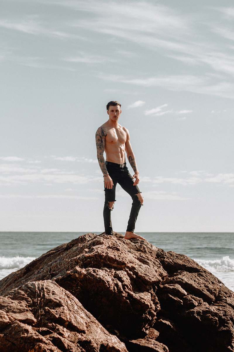 people man in black pants standing on hill human