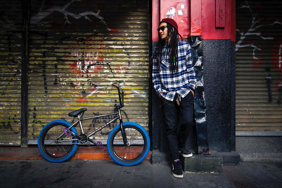 people man leaning on wall bike