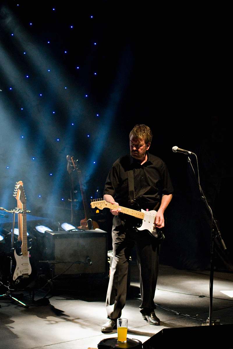 people man playing guitar in front of microphone human