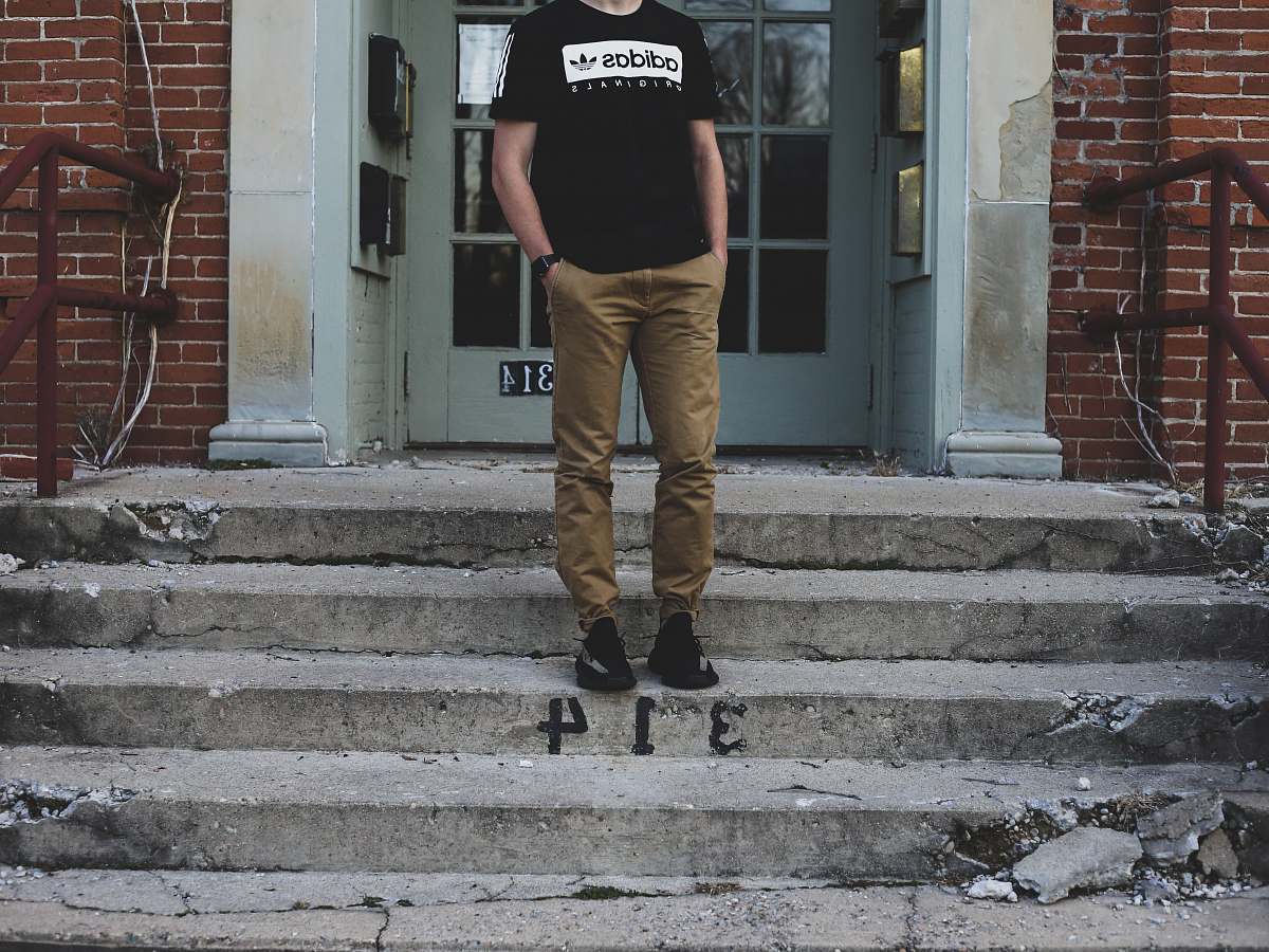 people man put his hand on his pocket while standing on stair human