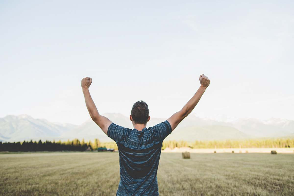 people man reaching hands up high taken at daytime human