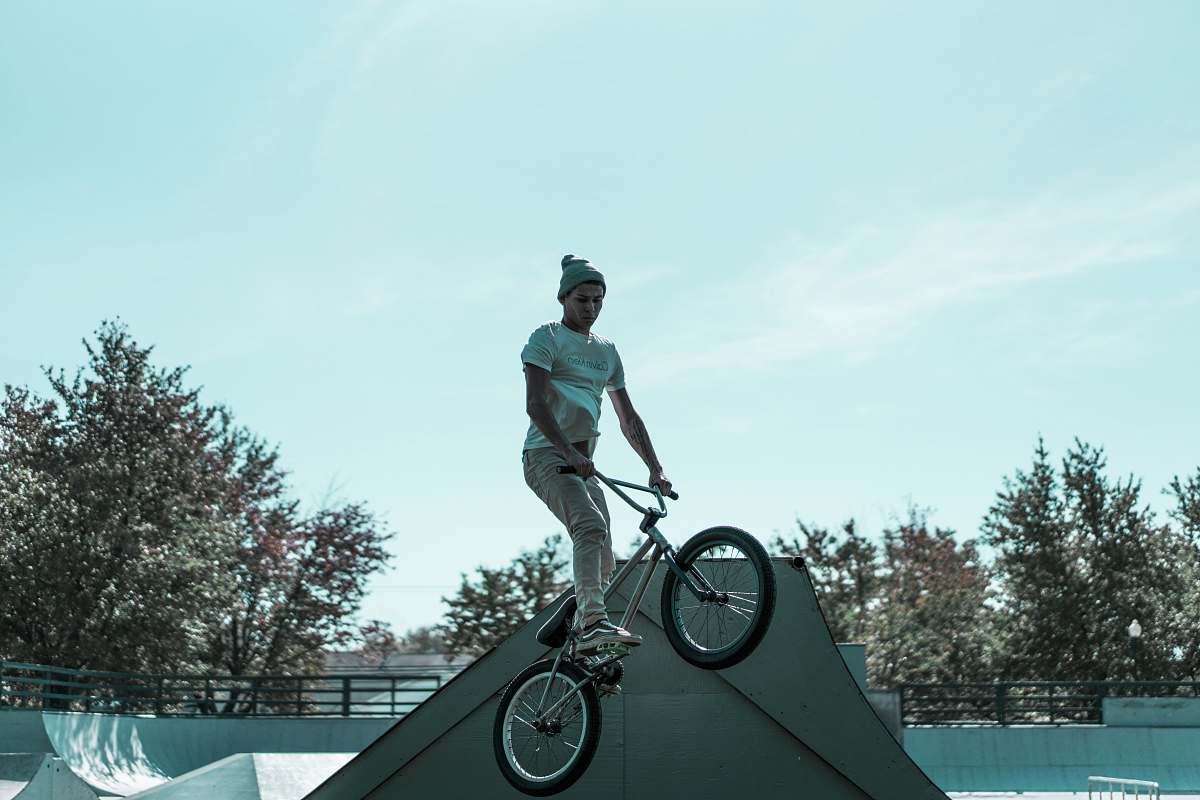 human man riding BMX bicycle during day time people