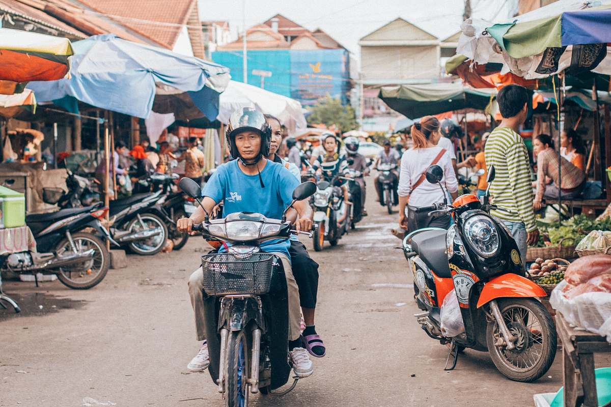 people man riding motor scooter motorcycle