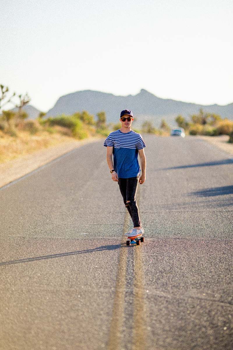 people man riding on skateboard on gray road during daytime human