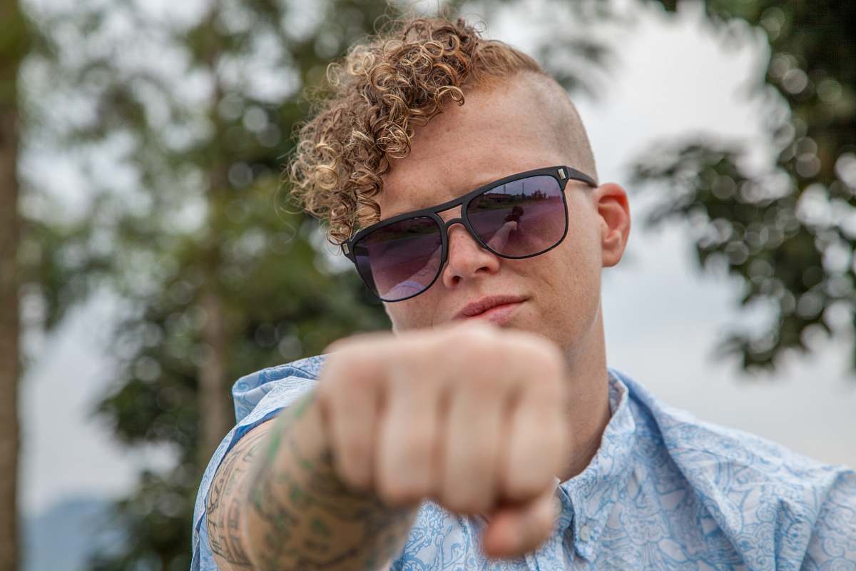 people man showing left fist during daytime human