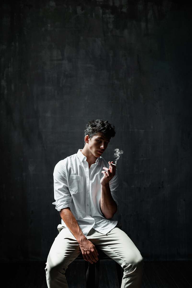 people man sitting on chair smoking cigar human