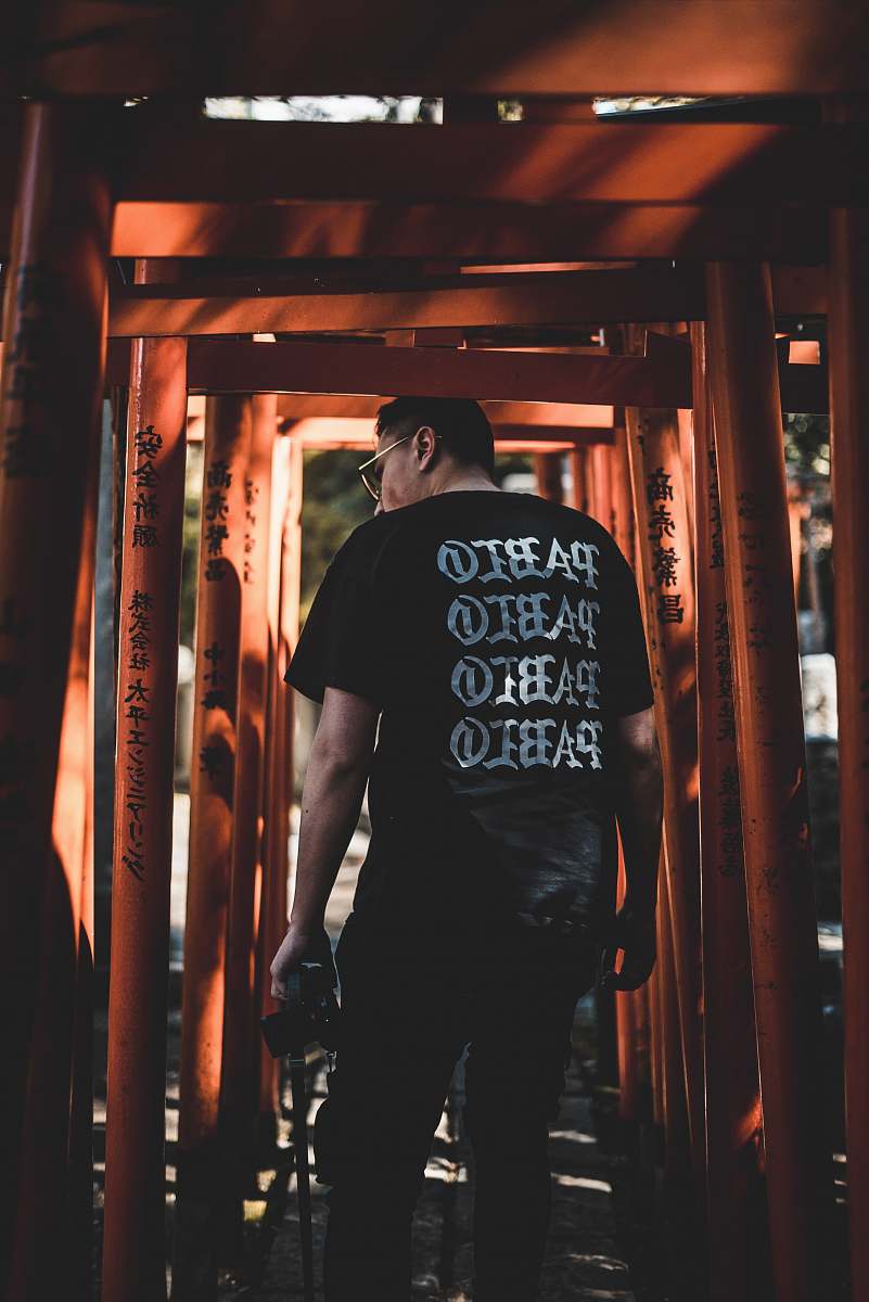 people man standing in between orange metal frames human
