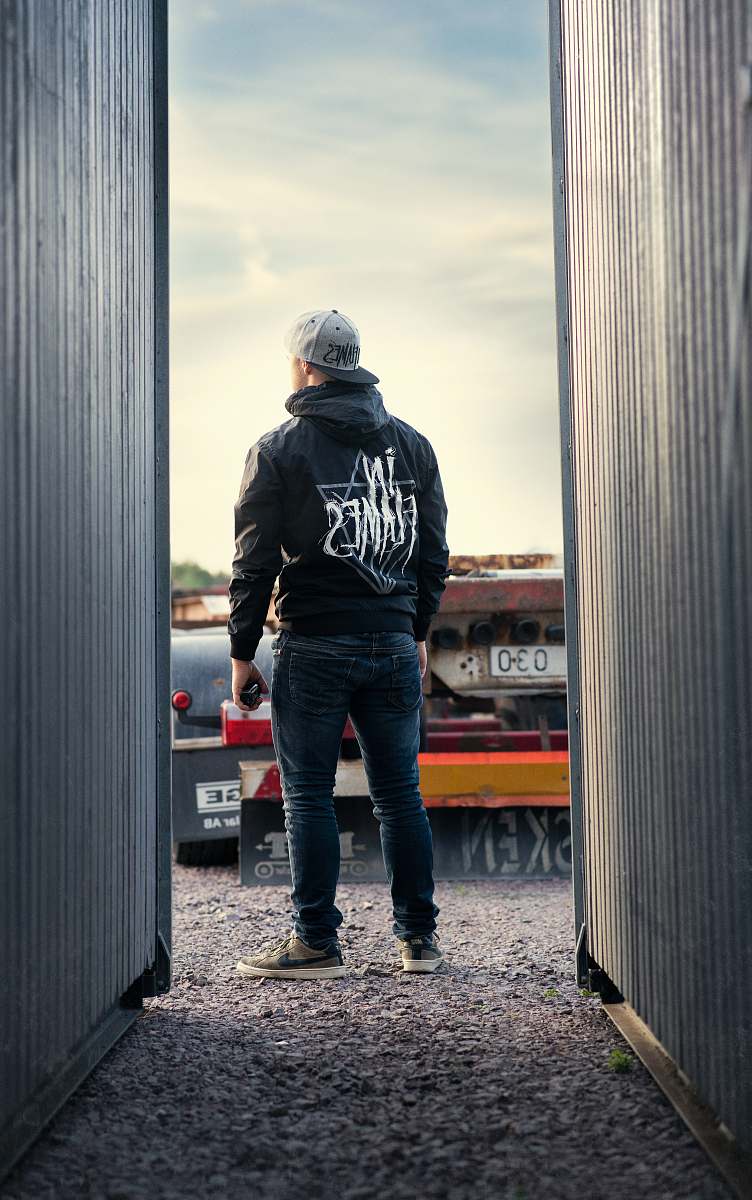 human man standing in middle of two corrugated sheets people