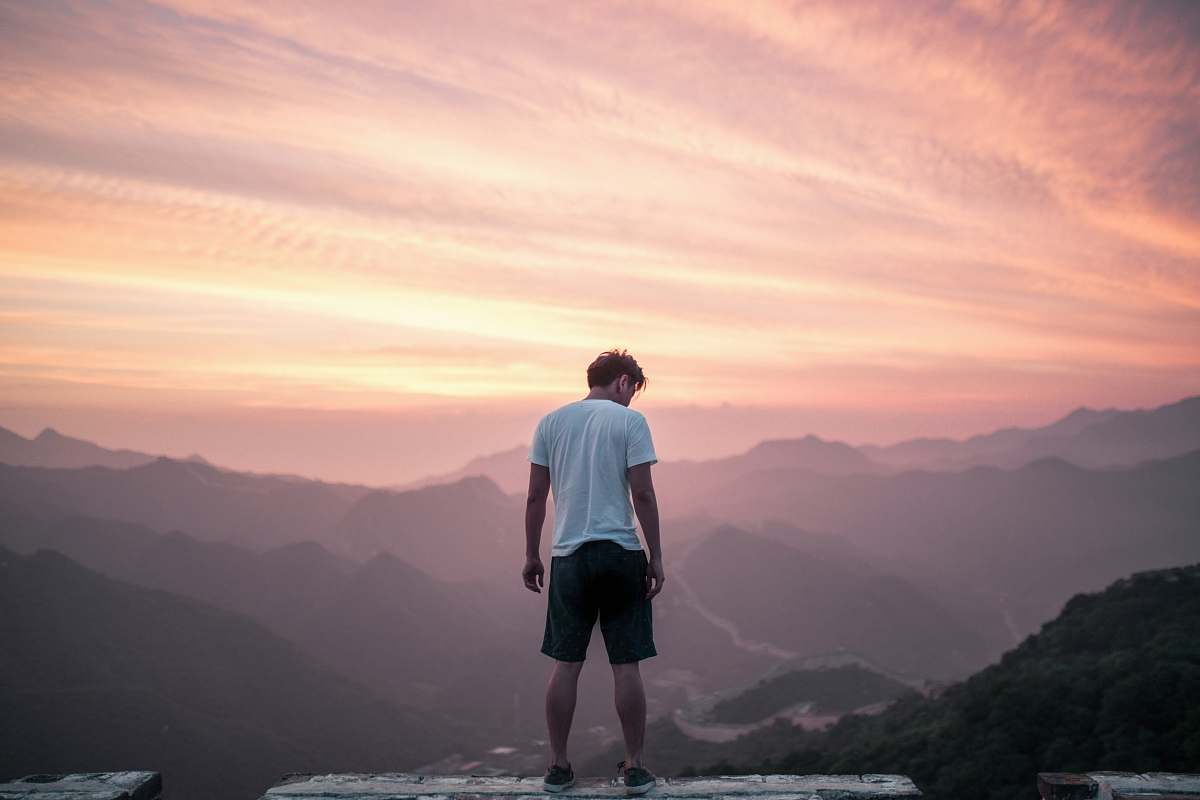 people man standing on cliff human