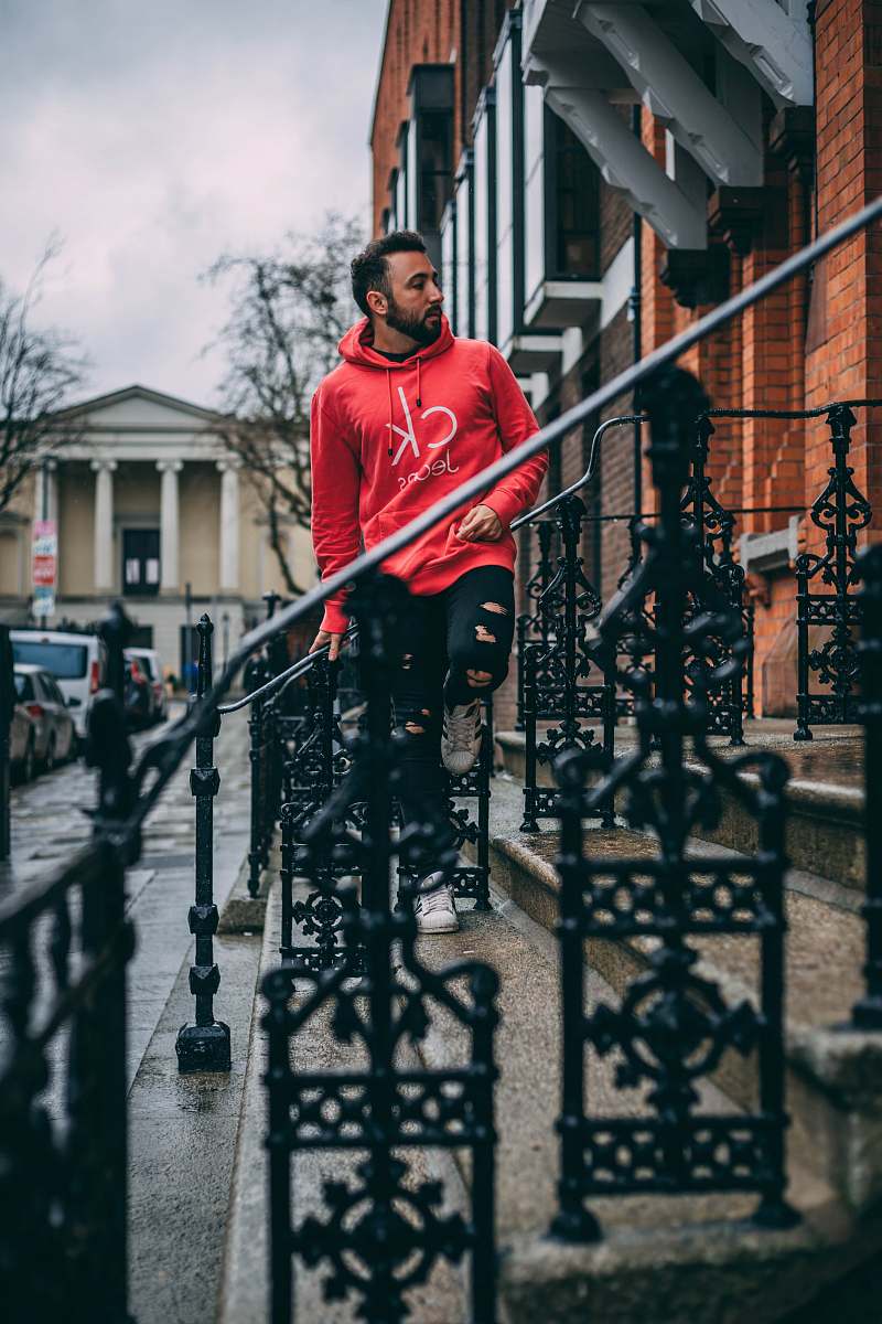 people man standing on gray stair near building taken at daytime human