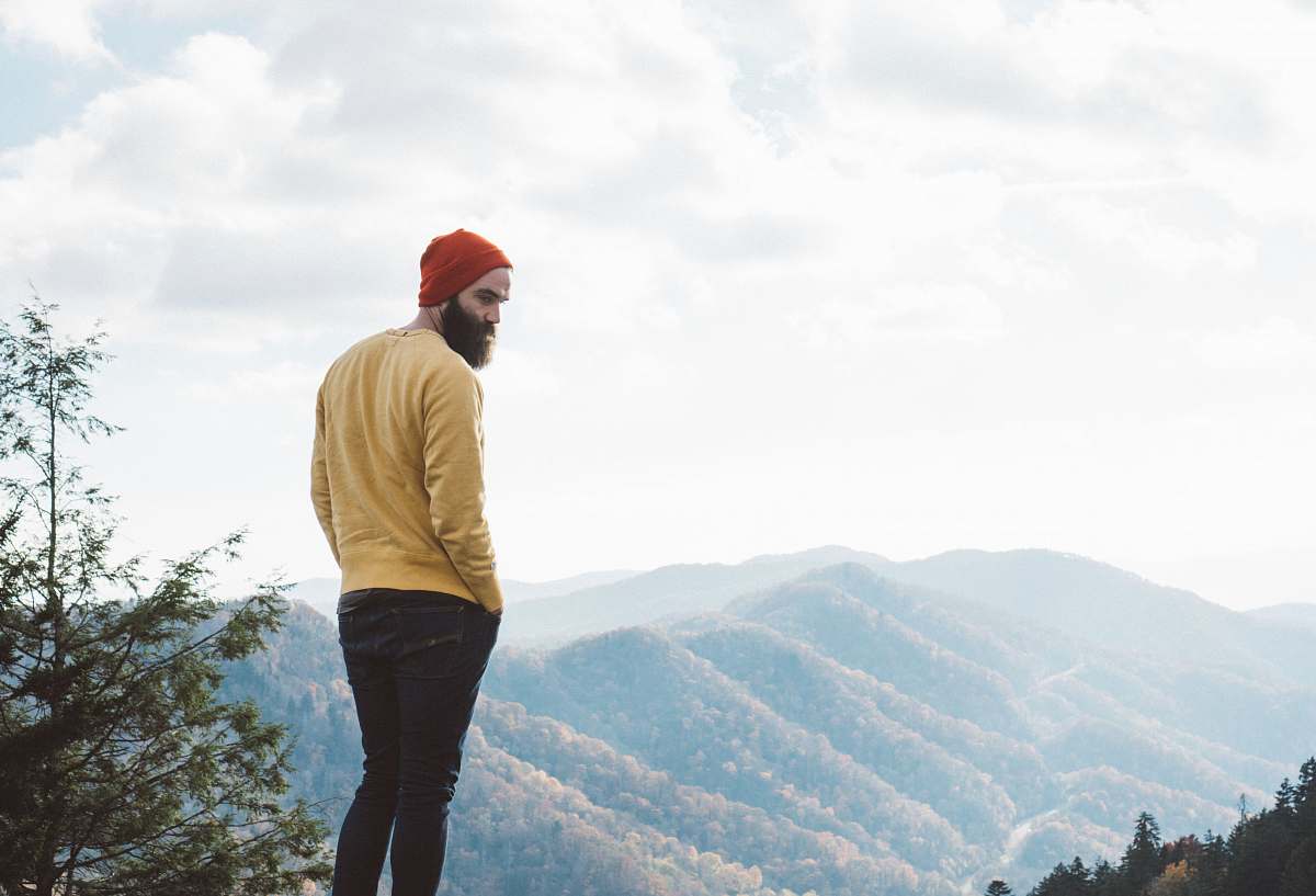 people man standing on top of hill human