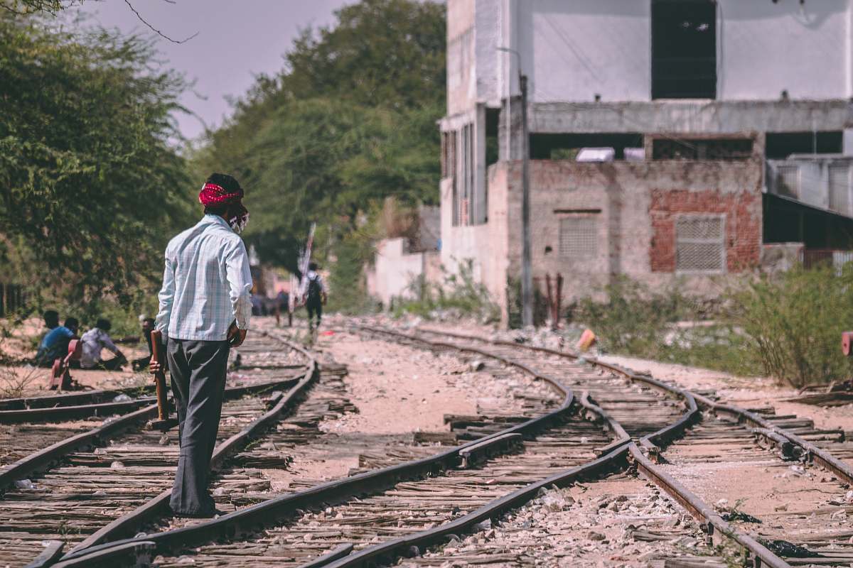 human man standing on train rails people