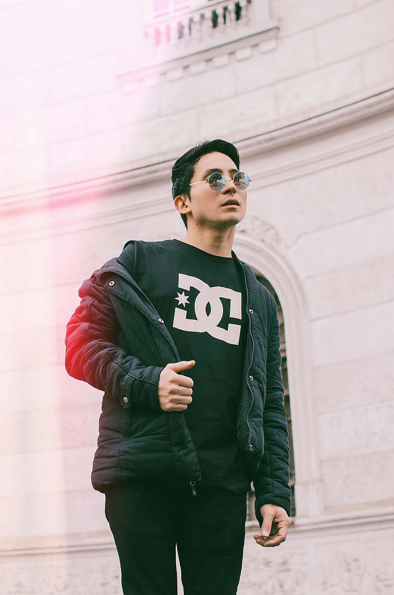 human man standing while holding his jacket people