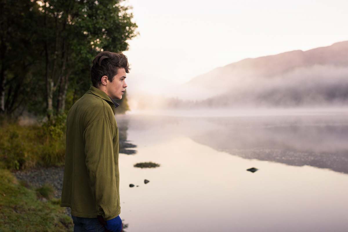people man staring at the body of water nature