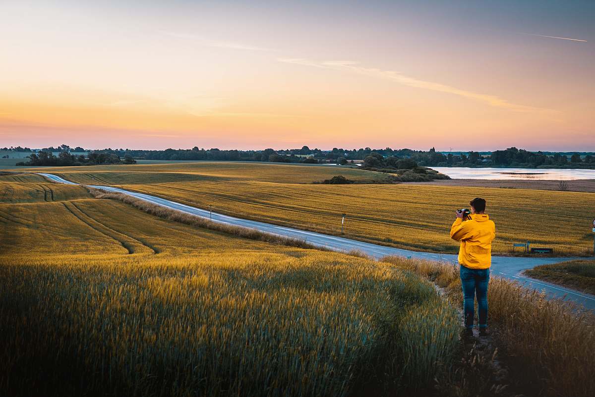 human man taking photo of grassland people