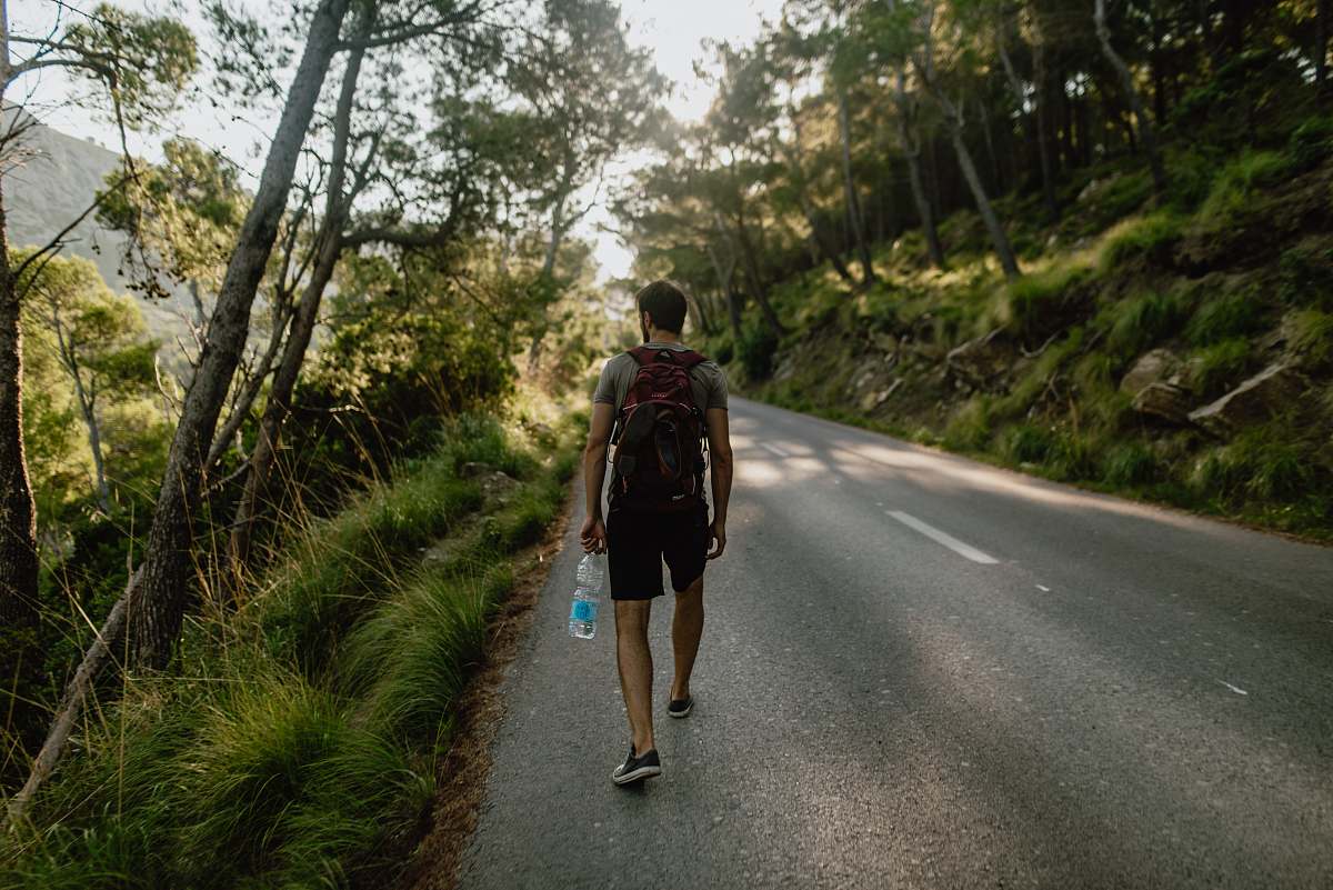 human man walking along pathway people
