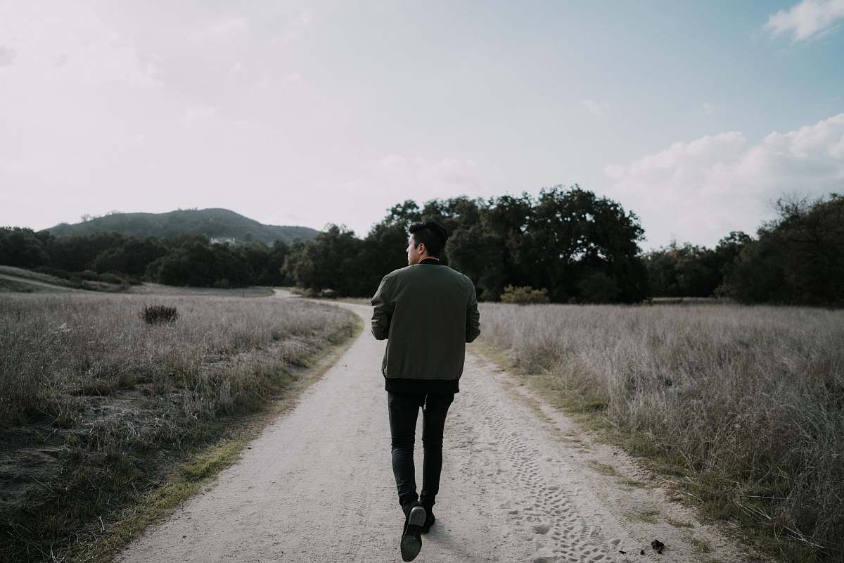 people man walking on empty road human